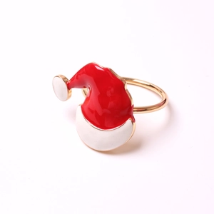 Detail of red enamel Santa hat napkin ring with gold plated finish for Christmas table decor