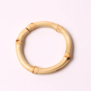 Natural bamboo napkin ring with distinct nodes and polished finish shown in top view
