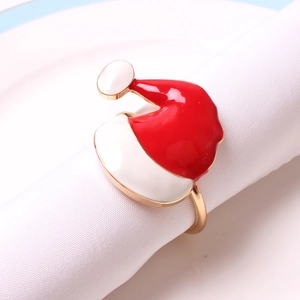 Christmas Santa hat napkin ring with gold metal band on a white linen napkin