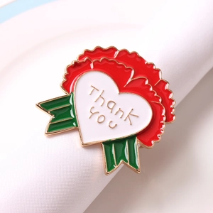 Macro view of red carnation napkin ring with heart-shaped thank you engraving and green leaves