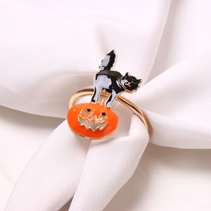 Halloween black cat and orange pumpkin napkin ring on white fabric for table decor