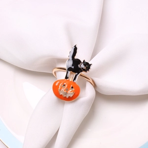 Detail of Halloween napkin ring with black cat and orange pumpkin enamel charm