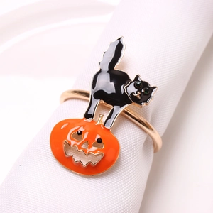 Detail view of a Halloween napkin ring featuring a black cat on an orange pumpkin