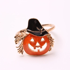 Close-up of Halloween pumpkin napkin ring with black wizard hat and gold metal details