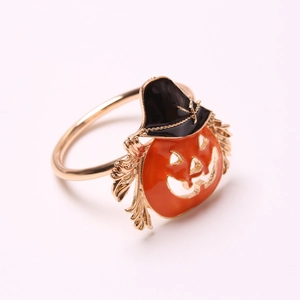 Detail of Halloween pumpkin napkin ring with black cat hat and gold metal band