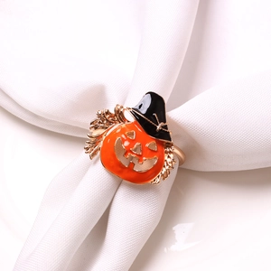 Detail of Halloween pumpkin napkin ring with black wizard hat on white cloth