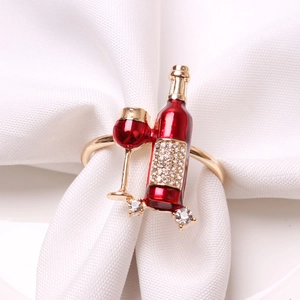 Detailed close-up of wine bottle napkin ring with red enamel and sparkling crystals