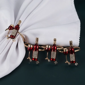 Set of 4 gold metal napkin rings featuring red enamel wine bottle and glass with rhinestones