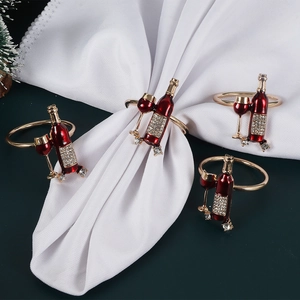 Elegant gold wine bottle and glass napkin rings set with red rhinestones for table decor