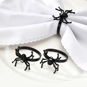 Halloween black spider napkin rings with rhinestones on a white plate and napkin