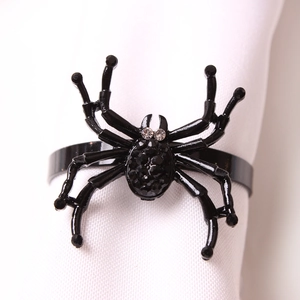 Halloween black spider napkin ring with sparkling rhinestones on white fabric
