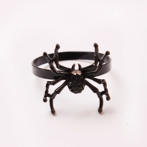Detailed view of a black spider napkin ring with sparkling crystals for Halloween tables