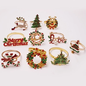 10-piece gold Christmas napkin ring set featuring reindeer, snowflakes and trees