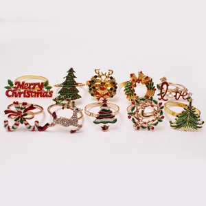 10-piece Christmas napkin ring set with gold metal reindeer, snowflake and tree motifs