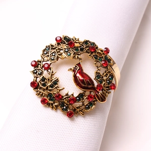 Detailed close-up of a festive cardinal bird napkin ring with red and green crystals