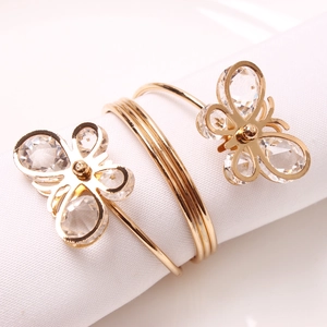 Golden spring metal napkin ring featuring elegant rhinestone studded butterfly details