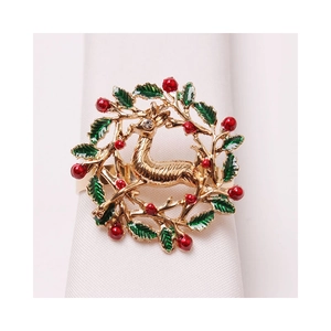Golden Christmas napkin ring featuring a reindeer with green wreath and red berries