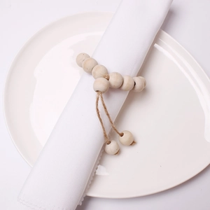 DIY wooden bead napkin rings in natural wood color for Christmas table decoration