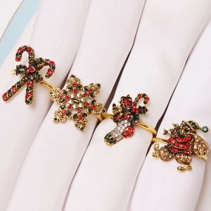 Golden Christmas napkin rings set with rhinestone reindeer, snowflake and santa designs