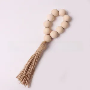 Close-up of wooden bead napkin ring with a natural jute tassel on a clean background