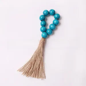 Detail of sky blue wooden bead napkin ring with natural jute rope tassel ornament