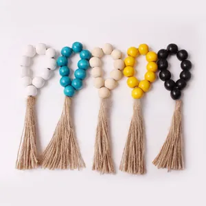 Detail of five-color wooden bead napkin rings with natural jute tassels for table decor