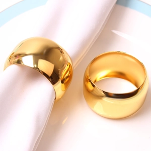 Golden polished drum-shaped metal napkin rings set for elegant wedding table decor