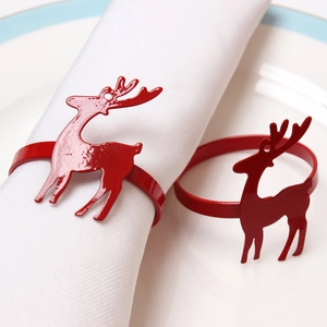 Christmas reindeer napkin ring in vibrant red lacquer metal on white table setting
