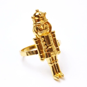 Close-up of golden nutcracker soldier napkin ring with detailed crown and uniform