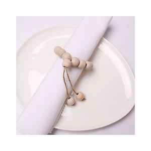 DIY Christmas wooden bead napkin rings with natural jute tassels for table decoration
