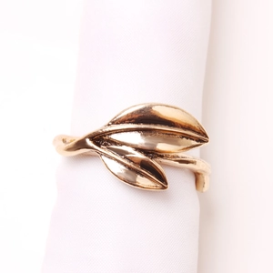 Close-up of golden leaf napkin ring featuring dual leaves with clear vein textures
