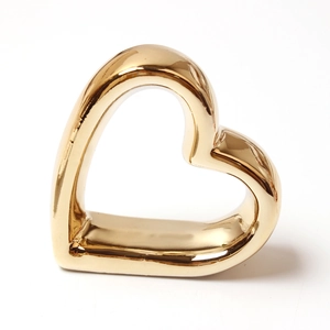 Macro view showing the polished rose gold finish and sleek heart shaped napkin ring detail