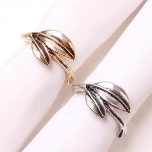 Leaf-shaped metal napkin rings in gold and silver finishes for elegant dining table decor