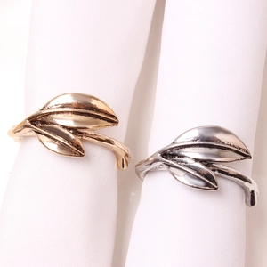 Elegant gold and silver leaf napkin rings set with polished metal leaf design