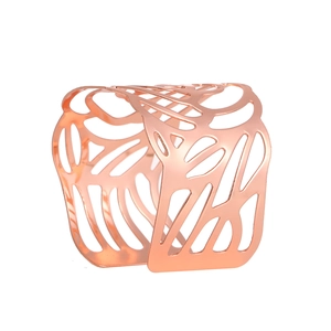 Rose gold hollow leaf pattern napkin ring with elegant metallic finish on white background