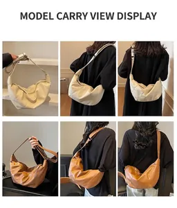 Detail view of large capacity crescent hobo bags in cream and caramel with adjustable straps