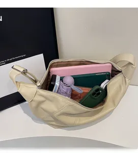Interior view of large capacity beige crossbody bag showing ample storage for gadgets