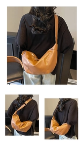Detail view of large brown leather hobo bag with adjustable strap and spacious design