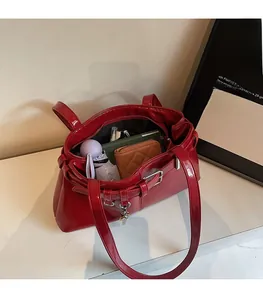 Interior view showing the large capacity of the red glossy tote bag for daily essentials