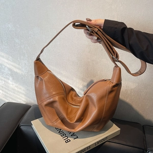 Brown leather crescent hobo bag with adjustable wide shoulder strap for casual daily use
