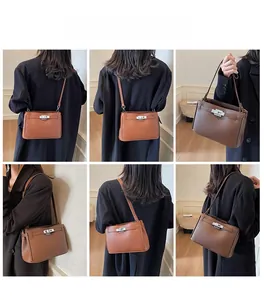 Detail view of model wearing vintage leather hobo bags in light and dark brown finishes