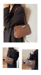 Detail view of brown lychee grain leather shoulder bag with silver turn-lock closure