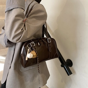 Deep brown retro soft leather tote bag with baseball pendant and silver zipper details