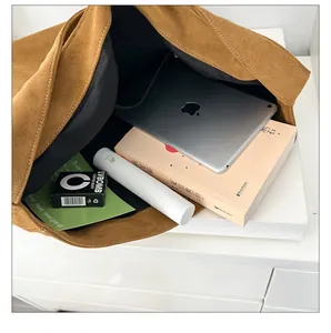 Interior view showing the large capacity and durable lining of the brown tote bag