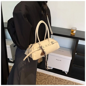 Detail of cream Boston bag with decorative strap and silk scarf on a slim shoulder strap