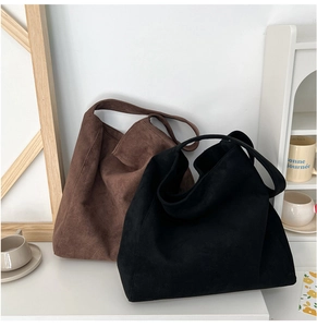 Detail showing high-quality suede texture on black and brown minimalist tote bags