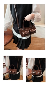 Detailed view of a vintage dark brown shoulder bag with double pockets and shiny finish