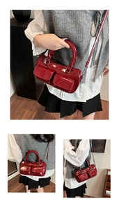 Detail of red patent leather bowling bag featuring multi-pocket design and dual handles