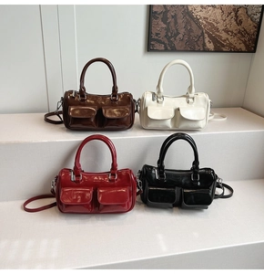 Detailed view of glossy Boston bags in four colors with dual front flap pockets