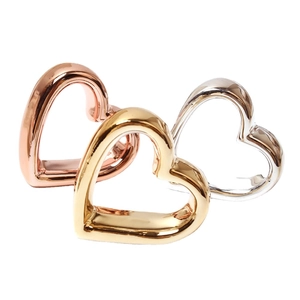 Three-piece heart-shaped napkin rings in rose gold, gold, and silver finishes for tables